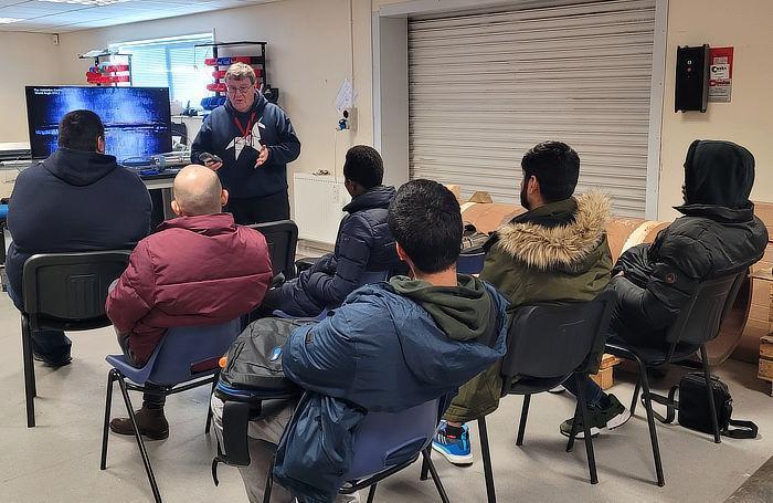 Cranfield University students listening to TVC staff member