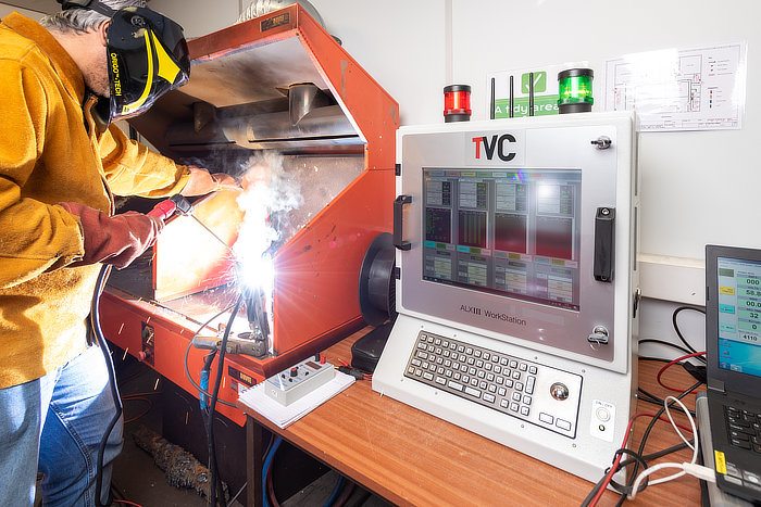 Man using Arc Logger Weld Monitoring equipment